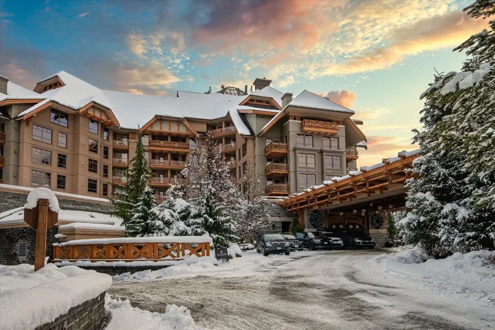 Snow covered building with a view of apartment building / complex