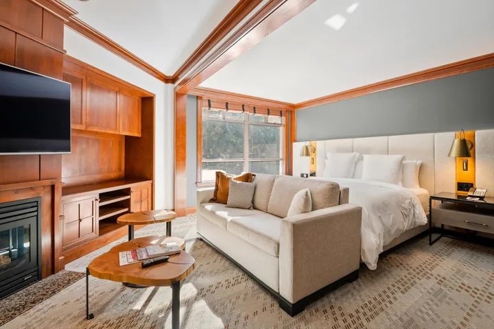 Bedroom featuring ornamental molding and a glass covered fireplace