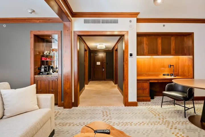Corridor with ornamental molding and a desk