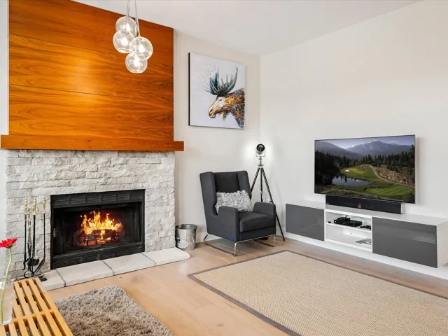 Living area with a fireplace and wood finished floors