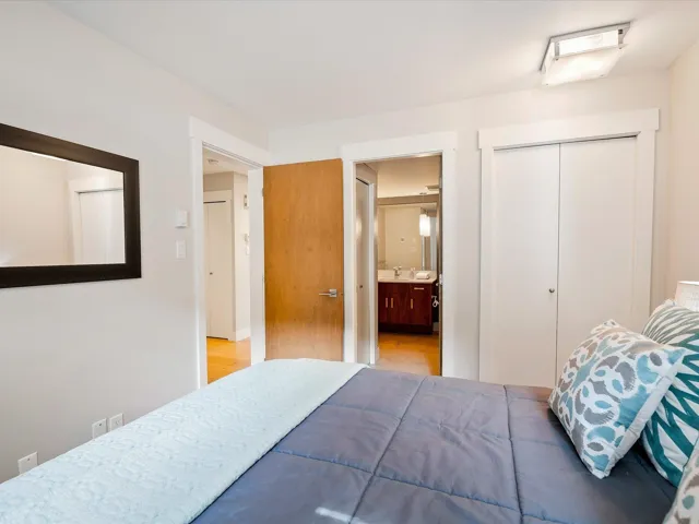 Bedroom with ensuite bathroom, a closet, and a sink