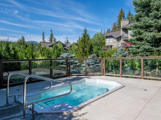 View of pool with an in ground hot tub