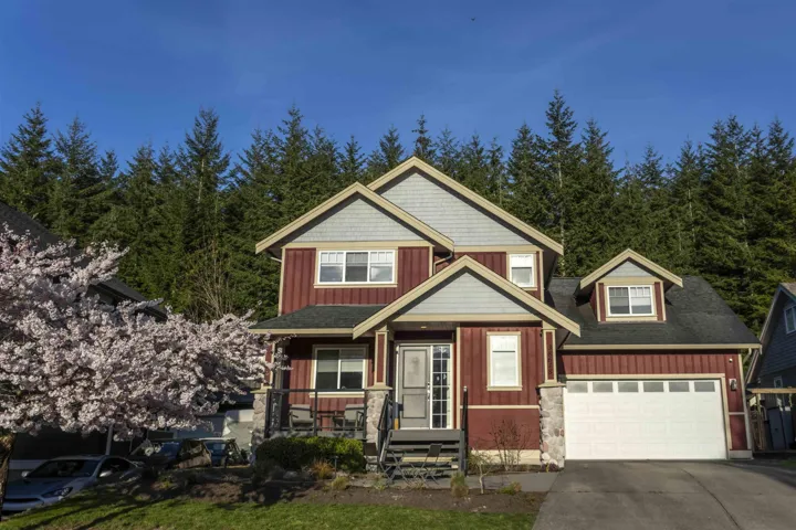 Craftsman house featuring a porch, driveway, board and batten siding, and an attached garage