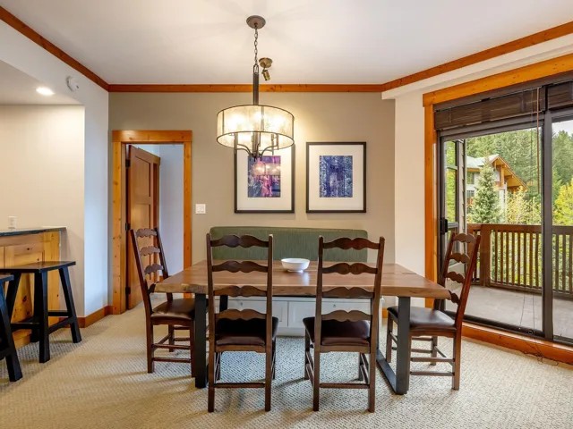 Dining space with a chandelier, light carpet, and crown molding