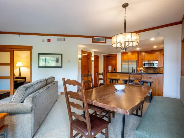 Dining area with light colored carpet, a chandelier, crown molding, and recessed lighting