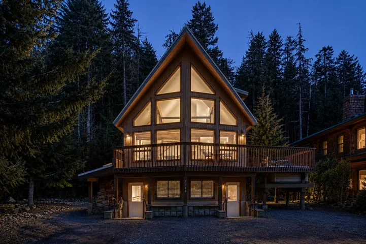 Rustic wood-sided lodge-style residence featuring a dramatic A-frame facade with extensive window coverage