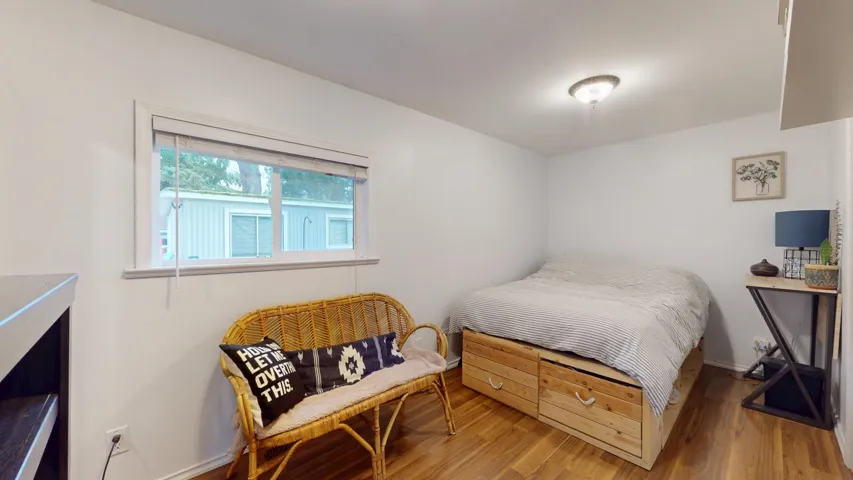 Bedroom with baseboards and light wood finished floors
