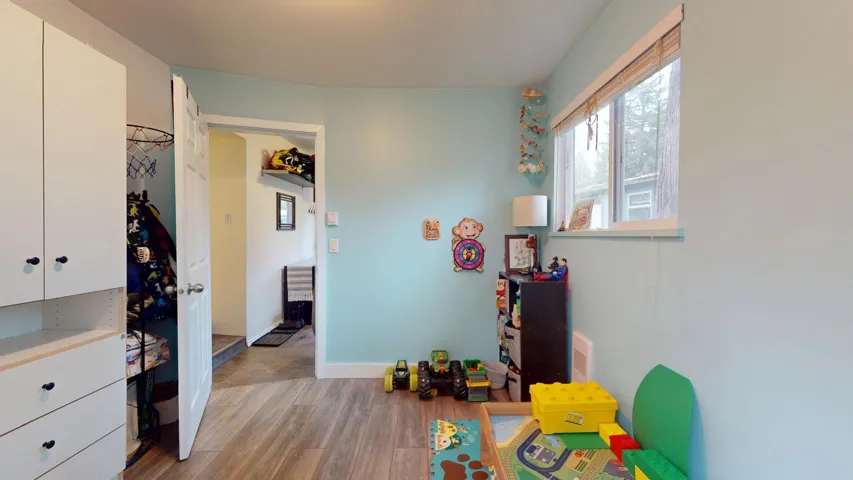 Rec room with light wood finished floors and baseboards