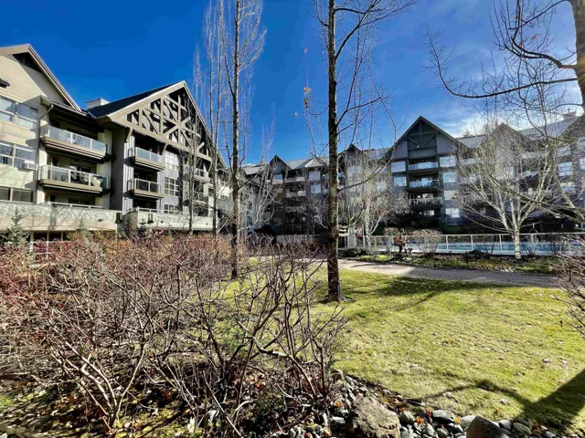 Expansive green space featuring mature trees and established shrubbery