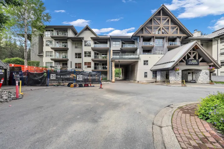 Building exterior featuring a prominent gabled entrance with stone accents