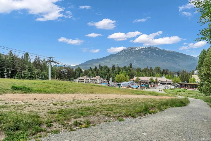Expansive outdoor area featuring a ski lift apparatus and a gravel path