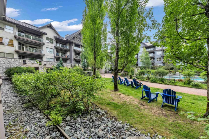 Landscaped communal grounds featuring mature trees and a gravel pathway