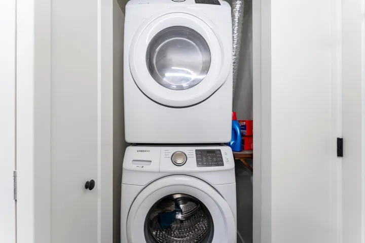 Laundry area featuring stacked washer / dryer