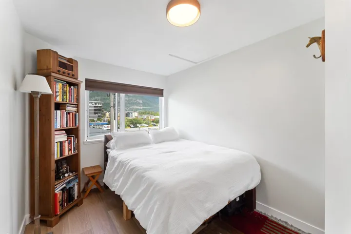 Bedroom with wood finished floors and baseboards