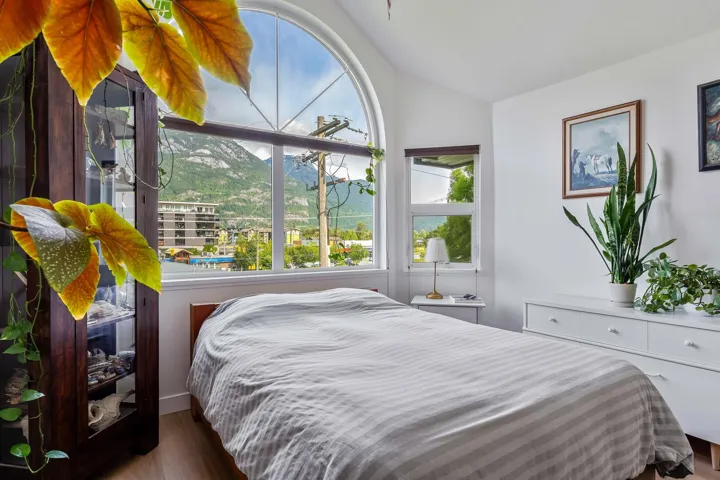 Bedroom featuring vaulted ceiling and dark wood-style flooring