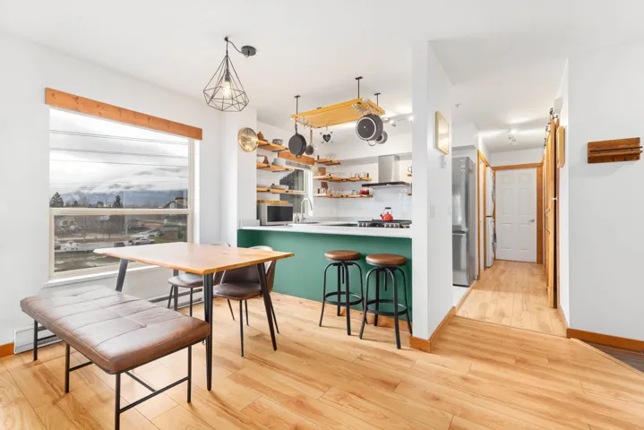 Dining space with a baseboard radiator, baseboards, and light wood finished floors