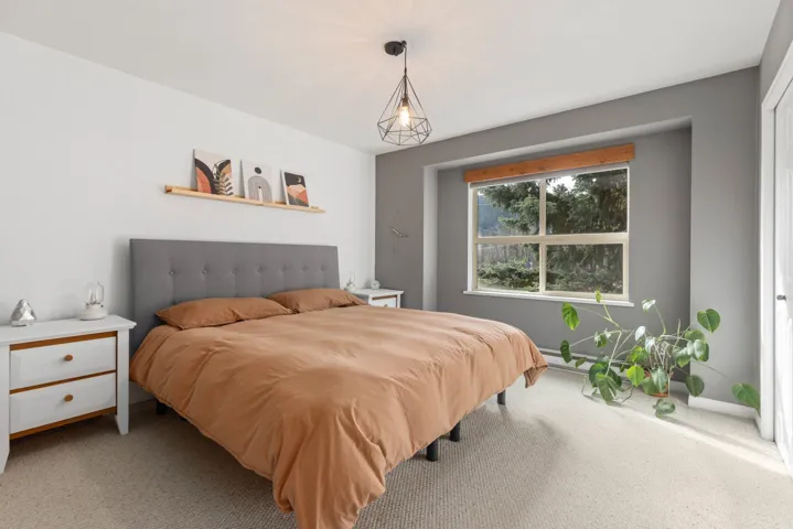 Bedroom with baseboards and light carpet