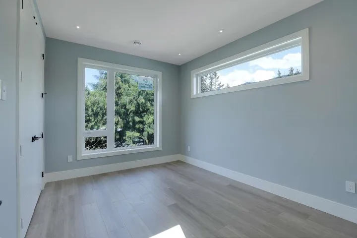 Empty room featuring light wood-style floors, baseboards, and recessed lighting