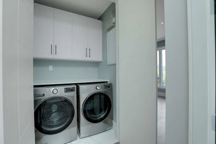 Laundry area with cabinet space and washing machine and dryer