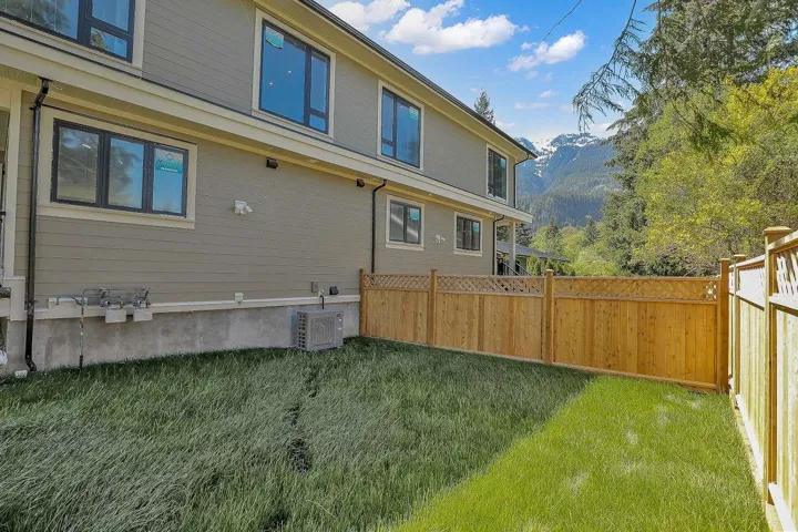 Back of property with a mountain view