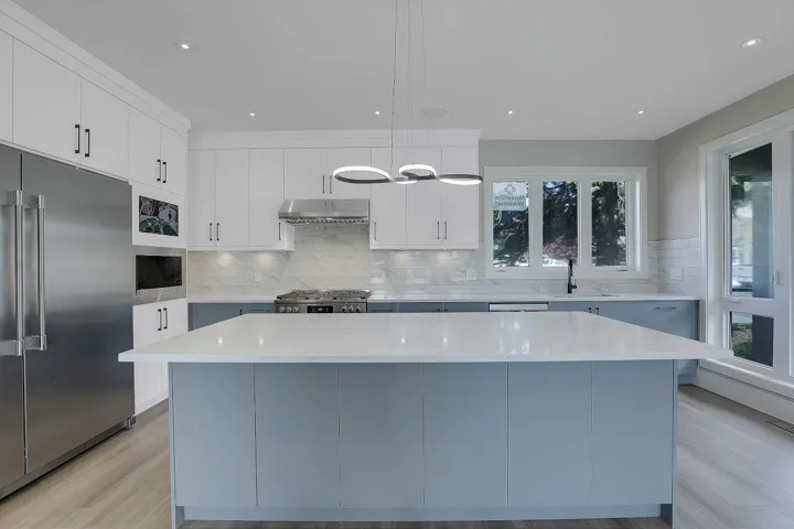 Kitchen with built in appliances, under cabinet range hood, light wood-type flooring, healthy amount of natural light, and recessed lighting