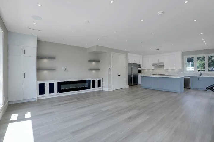 Unfurnished living room with a sink, light wood-style flooring, and recessed lighting