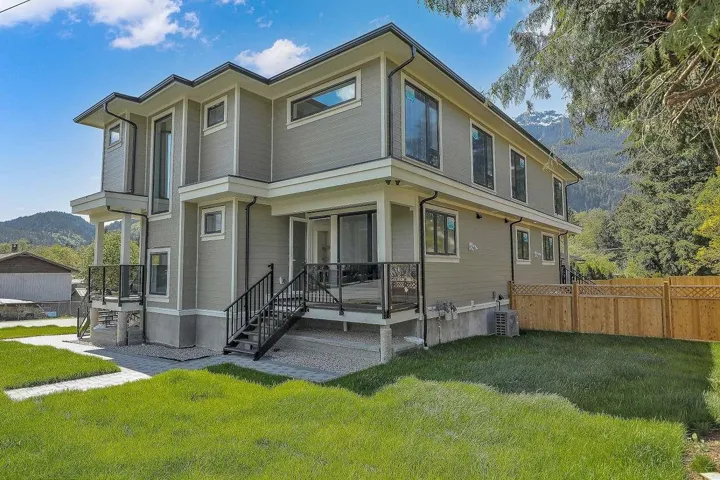 Rear view of house featuring central air condition unit and a mountain view