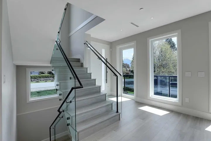 Stairway featuring baseboards, wood finished floors, and recessed lighting