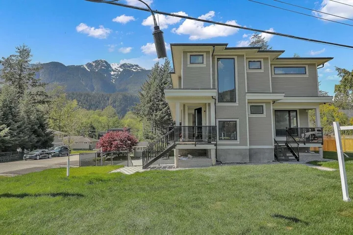 Rear view of property featuring a mountain view and stairs