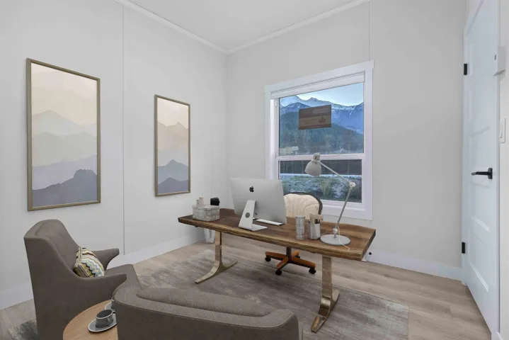 2nd bedroom shown as home office with crown molding and mountain view. Photo has been virtually staged.