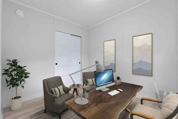 2nd bedroom shown as home office with vaulted ceiling, crown molding and mountain view. Photo has been virtually staged.
