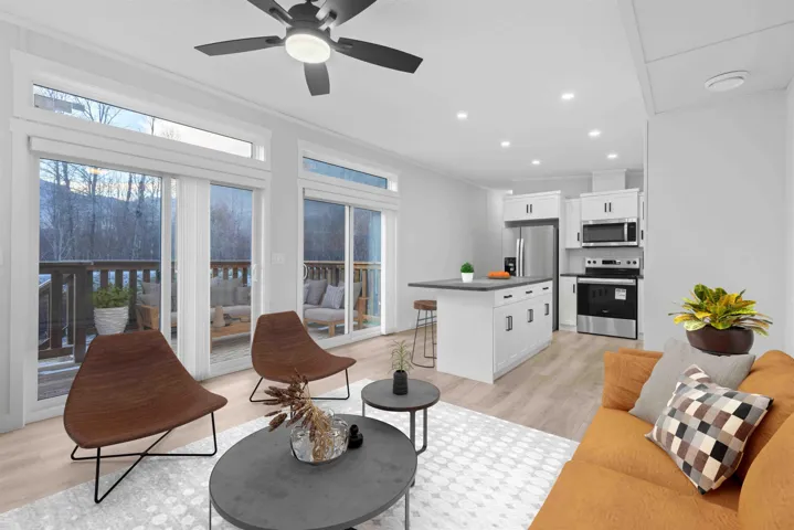 Living room features vaulted ceiling, split A/C, ceiling fan, crown molding, and recessed lighting. Photo has been virtually staged.