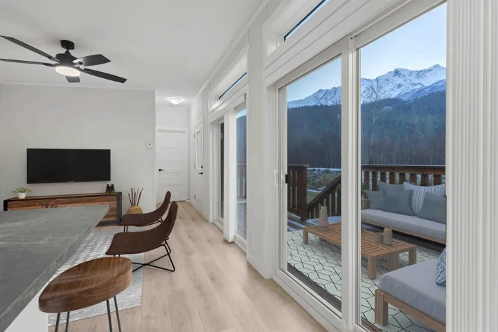 Eating area with mountain view, vaulted ceiling, plenty of natural light, A/C and ceiling fan. Photo has been virtually staged.