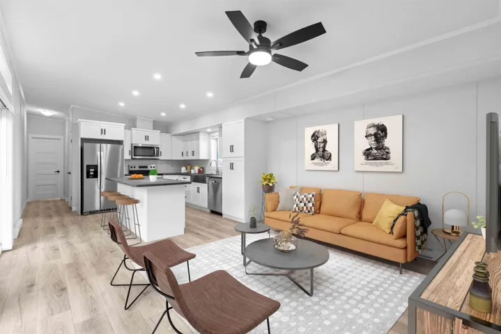 Living room features vaulted ceiling, split A/C, ceiling fan, crown molding, and recessed lighting. Photo has been virtually staged.