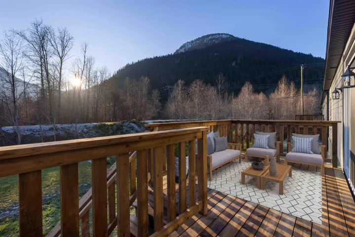 Spacious wood deck front entry with mountain view. Photo has been virtually staged.