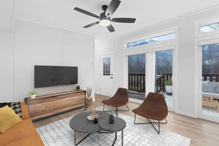 Living room features vaulted ceiling, split A/C, ceiling fan, crown molding, and recessed lighting. Photo has been virtually staged.