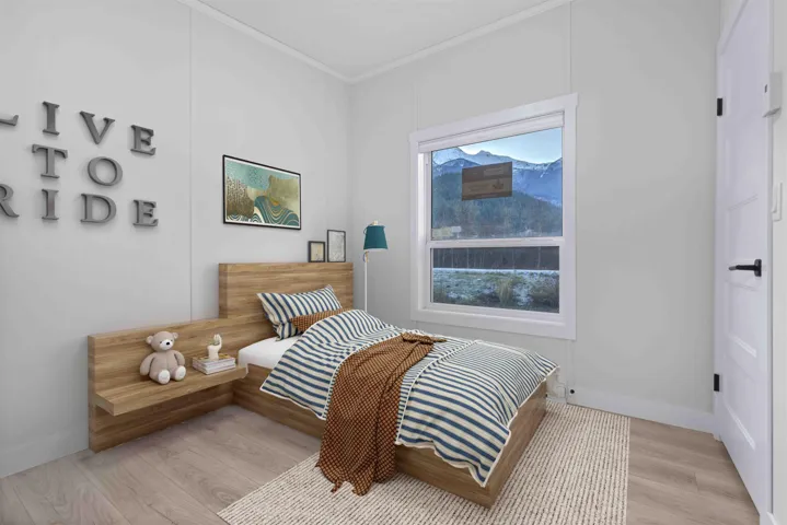 Bedroom featuring vaulted ceiling with crown molding and mountain view. Photo has been virtually staged.