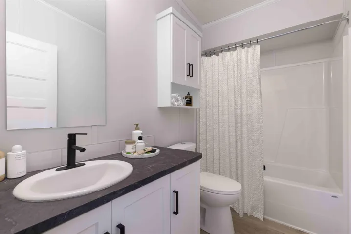 4pc bath featuring crown molding, shower / bathtub combination, and vanity. Photo has been virtually staged.
