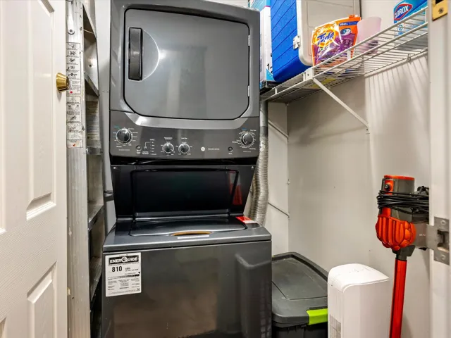 Laundry area featuring stacked washer / drying machine