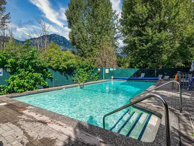 View of swimming pool featuring a fenced backyard, a mountain view, and a patio area