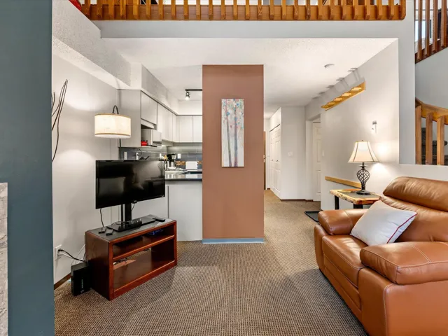 Living room with light carpet and a textured ceiling