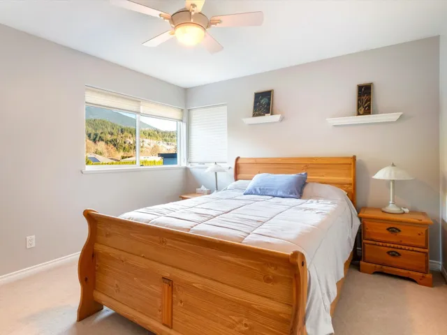 Bedroom with carpet floors, baseboards, a mountain view, and a ceiling fan