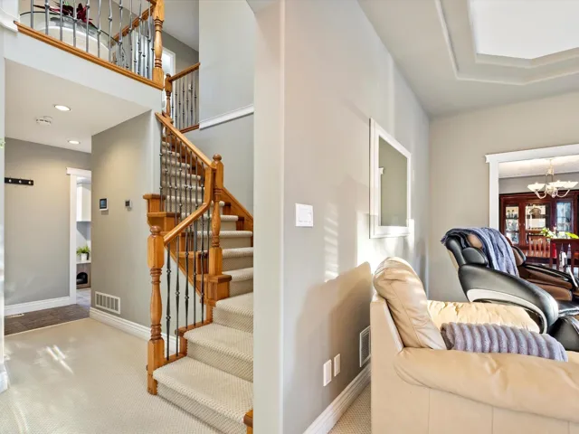 Staircase featuring recessed lighting, visible vents, a notable chandelier, and baseboards