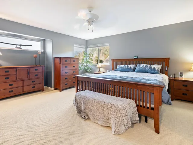 Bedroom featuring light carpet and a ceiling fan