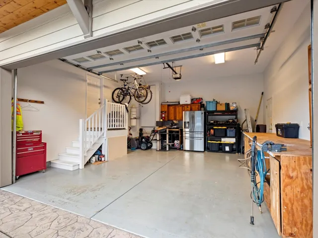 Garage with stainless steel refrigerator with ice dispenser