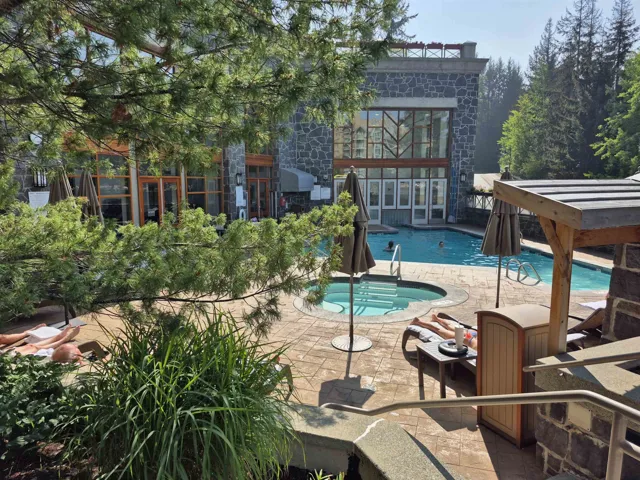 Community pool with a community hot tub and a patio