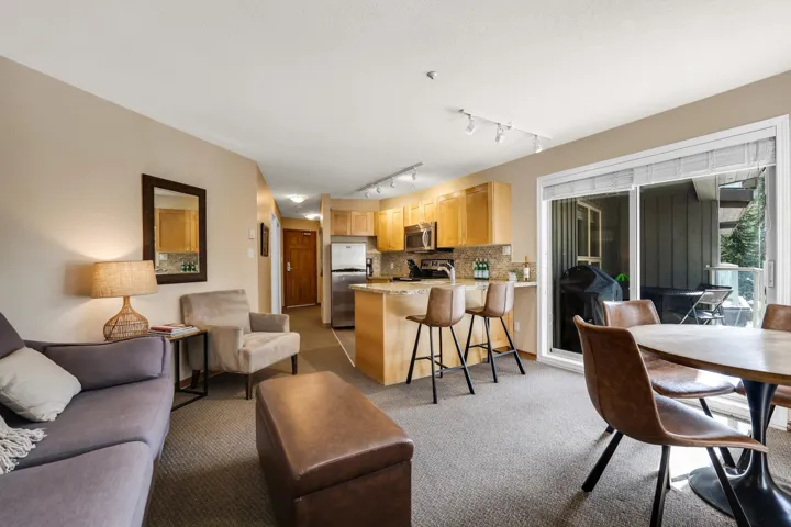Living room featuring rail lighting and light colored carpet