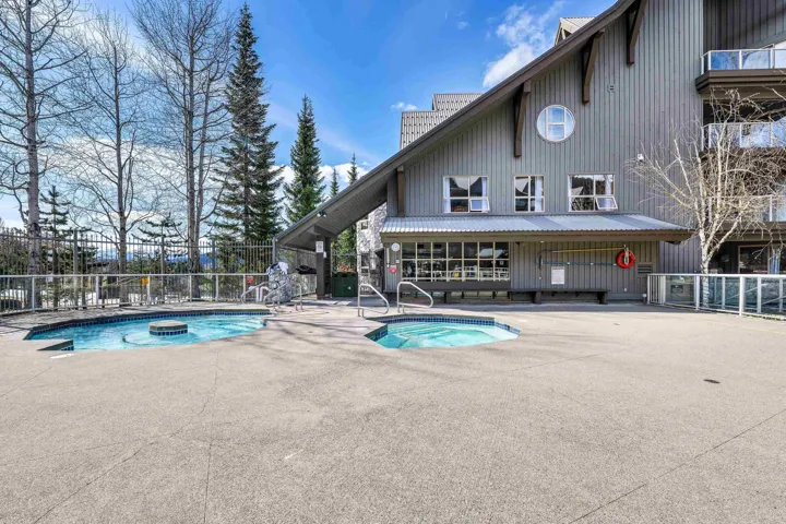 View of pool featuring a pool, a community hot tub, and patio surround