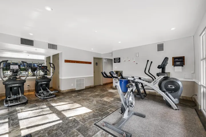 Workout room with wainscoting and recessed lighting
