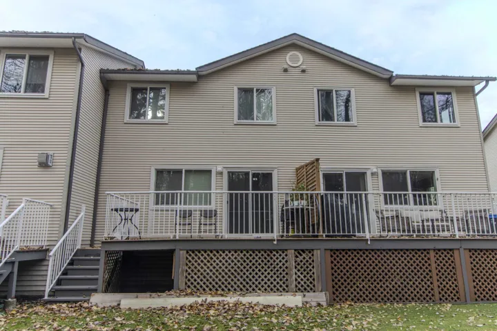 Back of property with a wooden deck